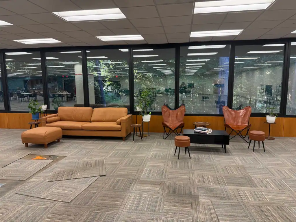 Sofa and lounge chairs beside the windows in Tributary’s shared coworking area