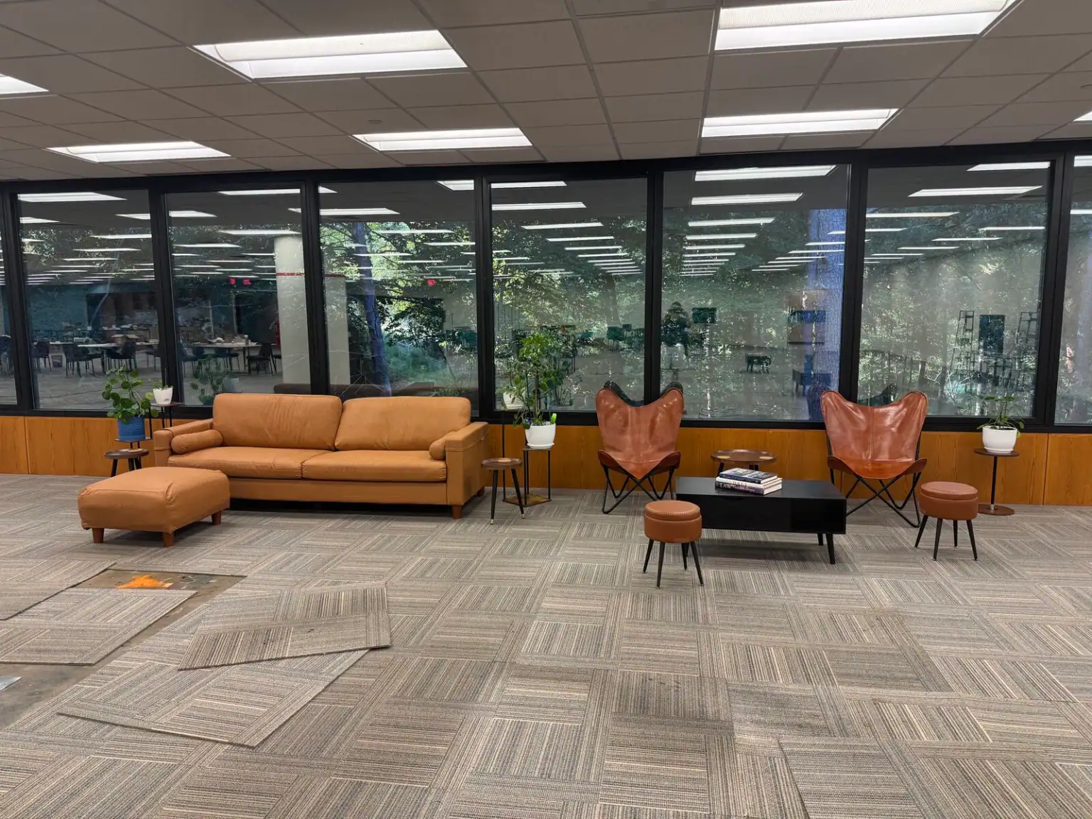 Sofa and lounge chairs beside the windows in Tributary’s shared coworking area